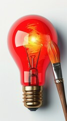 Creative concept of a red light bulb with a paintbrush, symbolizing innovative ideas and artistic creativity.