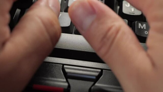 Black Laptop Spacebar Hit. Person types and hits the spacebar on a laptop.