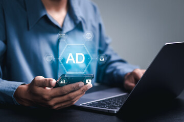 Online advertisement concept. Businessman using smartphone with advertising icon on virtual screen. AD on website or social media, online ads and digital marketing.