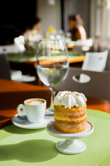 Gourmet small Cake with Coffee on a Restaurant Table