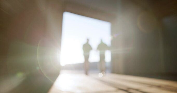 Light, flare and people with walking in warehouse for construction, planning or collaboration. Industry, teamwork and workers with communication in factory for property, building or bokeh of sunshine