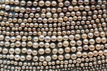 lots of pearl necklaces on the table in the store. necklace jumble