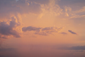 Golden and black clouds in the sky before the sun sets.