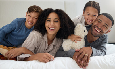 Family, portrait and support in home bedroom with smile for wellness, relationship and trust in morning. Parents, face and children on bed for happy, bonding and relax together with hug on weekend