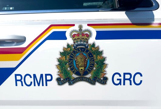 Calgary, Alberta, Canada. Jul 10, 2024. A close-up front view of the emblem on a Royal Canadian Mounted Police (RCMP) vehicle.