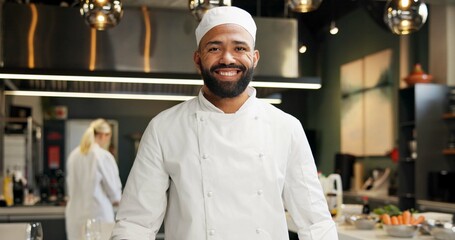 Man, head chef and portrait in kitchen or restaurant, happy and smile in food business with...