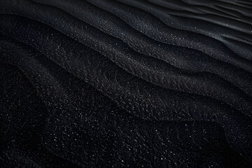 Black Sand dune. Black Sand beach macro photography. Background, texture, wave pattern of oceanic sand on the beach, black. Texture of beach sand. Black beach.