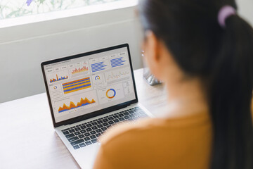 Businesswoman Analyzing Dashboard Data on Laptop.