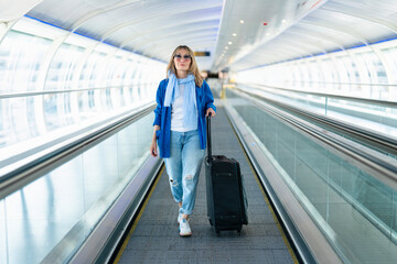 Woman Walking on Airport Moving Walkway