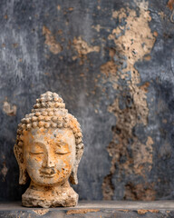 Buddha Head Statue on Textured Rustic Background