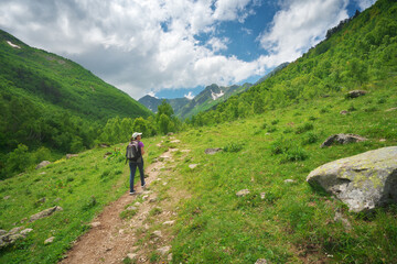 Young woman walking in mountain valley.