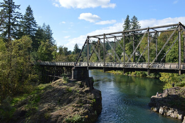 Fototapeta premium Bridge Over Tranquil River in the Pacific Northwest