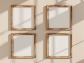 Fototapeta premium Four empty wooden frames hanging on beige colored wall. Picture frame mockup template background.