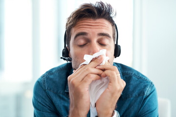 Flu, headset and man with tissue, desk and consultant in agency, sick and customer service in...