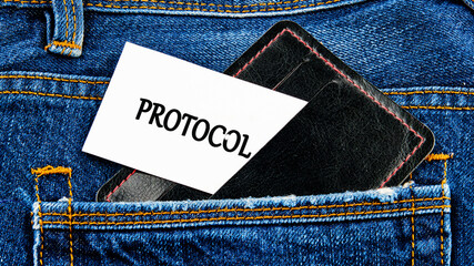 Business concept. Text PROTOCOL is written on a business card from a black wallet sticking out of a jeans pocket