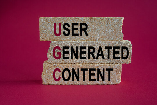 UGC user generated content symbol. Concept words UGC user generated content on brick blocks. Beautiful red background. Business and UGC user generated content concept.