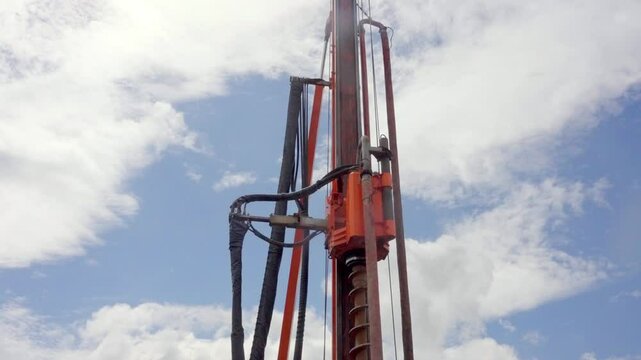 Drilling Piling Rig Operating in Daylight With Cloudy Sky