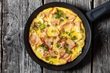 deli ham onion omelette on skillet, top view