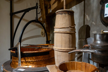 Old equipment for cheese production, wheels, rounds of Comte cheese made from raw cow milk, Jura, France