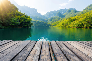 Fototapeta premium A serene lakeside view with turquoise water and lush green hills under a clear blue sky, perfect for nature enthusiasts and tranquil retreats.