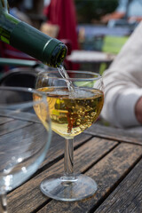 Tasting of Bordeaux white wine, right bank of Gironde Estuary, France. Glasses of white sweet French wine served in outdoor restaurant