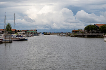 Fototapeta premium Travelling in France, old wooden huts and oysters farms in Gujan-Mestras village, cultivation and sale of fresh oysters seashells, Arcachon bay, Atlantic ocean, France, tourists destination