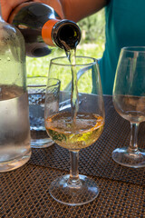 Tasting of Bordeaux white wine in Sauternes, left bank of Gironde Estuary, France. Glasses of white sweet French wine served in restaurant