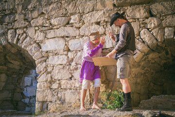 An Arab mercenary bargains with an Archaeologist against the backdrop of an ancient fortress. Historical reconstruction of archaeological research of the 19th century. Blogging. Social media