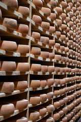 Aging rooms with shelves in cheese caves, central location for aging of wheels, rounds of Comte cheese from four months to several years made from unpasteurised cow milk, Jura, France