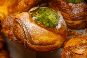 Fresh baked pastries for breakfast, pistachio croissant with cream filling