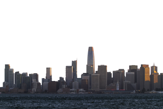 A skyline view of San Francisco illuminated by the sunset, on the background of a clear sky