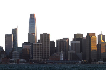 A city skyline with prominent buildings lit by sunset, with water in the foreground and a clear sky