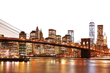 A vibrant night view of Manhattan skyline with the Brooklyn Bridge, illuminated buildings, and...