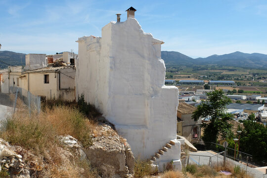 View from a hill on the town of Castalla. A house has been demolished and the white house next door now has a staircase that goes nowhere