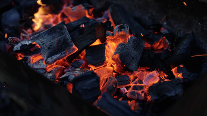 Handheld shot of charcoal in brazier, preparation for bbq © GCapture