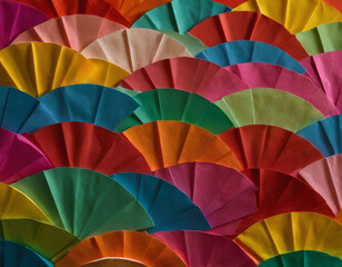 Obraz premium A simple flat lay of assorted colored paper sheets, neatly stacked and fanned out on a plain surface.