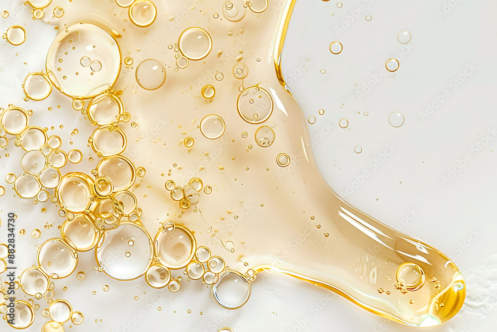 Wall mural yellow texture of a drop of whey or olive oil on a white background. transparent sample of cosmetic 