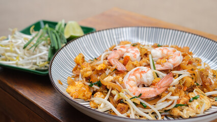 Pad Thai with shrimp and vegetables on  the table