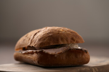 Ciabatta sandwich with ham and pesto closeup