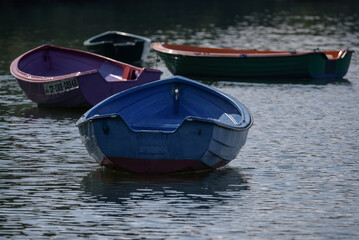 Naklejka premium LANDSCAPE BY THE LAKE - Small old rowing boats on the lake 