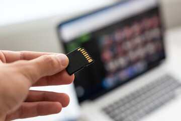 Hand holding sim card, micro sd chip