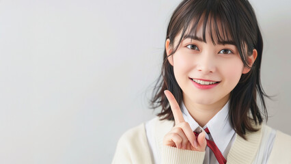 人差し指を立てる女子高生