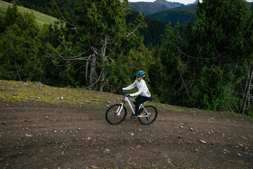 Riding mountain bike on forest mountain trail