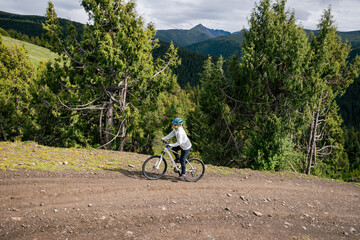 Riding mountain bike on forest mountain trail