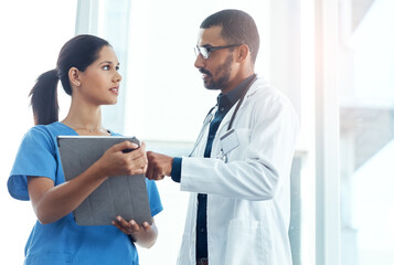 Medical, research or tablet with doctor and nurse in hospital for collaboration, diagnosis or discussion. Consulting, healthcare or feedback with medicine professional man and woman in clinic