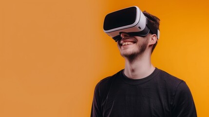 Handsome young man with a cheerful expression, wearing a modern VR headset against a bright solid orange background with copy space
