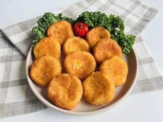 Home made potato croquettes - mashed potatoes balls with grated mozzarella cheese seasoned with spices; breaded and deep fried in olive oil
