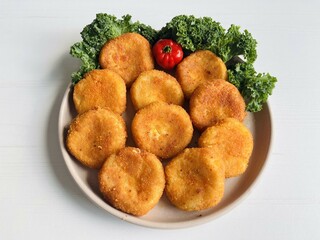 Home made potato croquettes - mashed potatoes balls with grated mozzarella cheese seasoned with spices; breaded and deep fried in olive oil