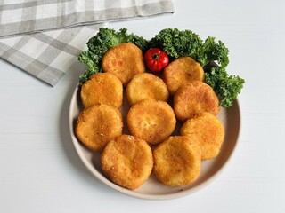 Home made potato croquettes - mashed potatoes balls with grated mozzarella cheese seasoned with spices; breaded and deep fried in olive oil