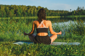 Beautiful woman exercising near the lake